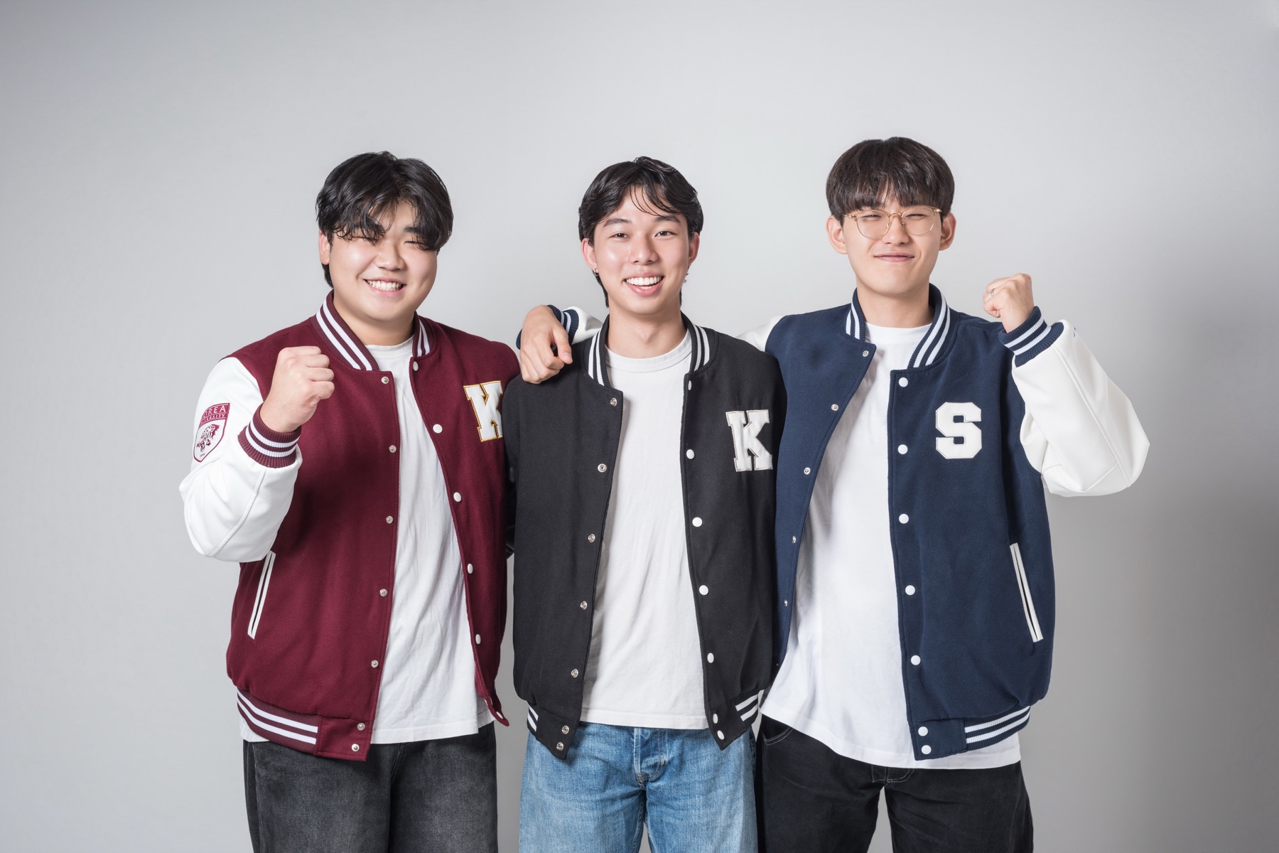 The three Seonbae founders standing together in university varsity jackets